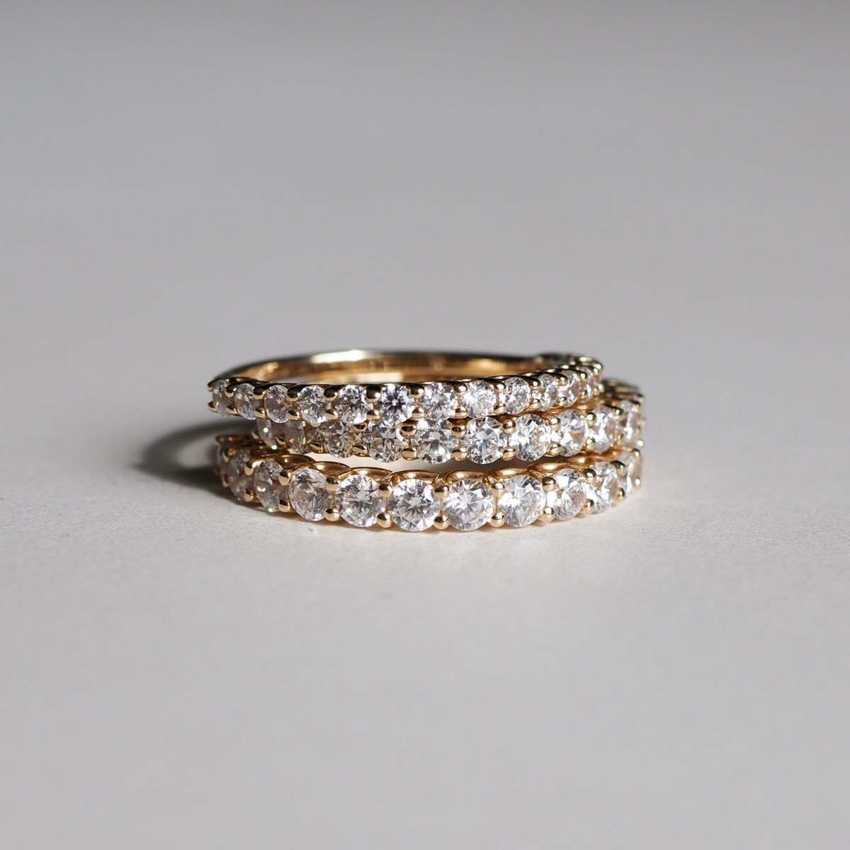 Stack of our Arraya diamond rings featuring our 2mm, 2.5mm and 3mm diamond bands 