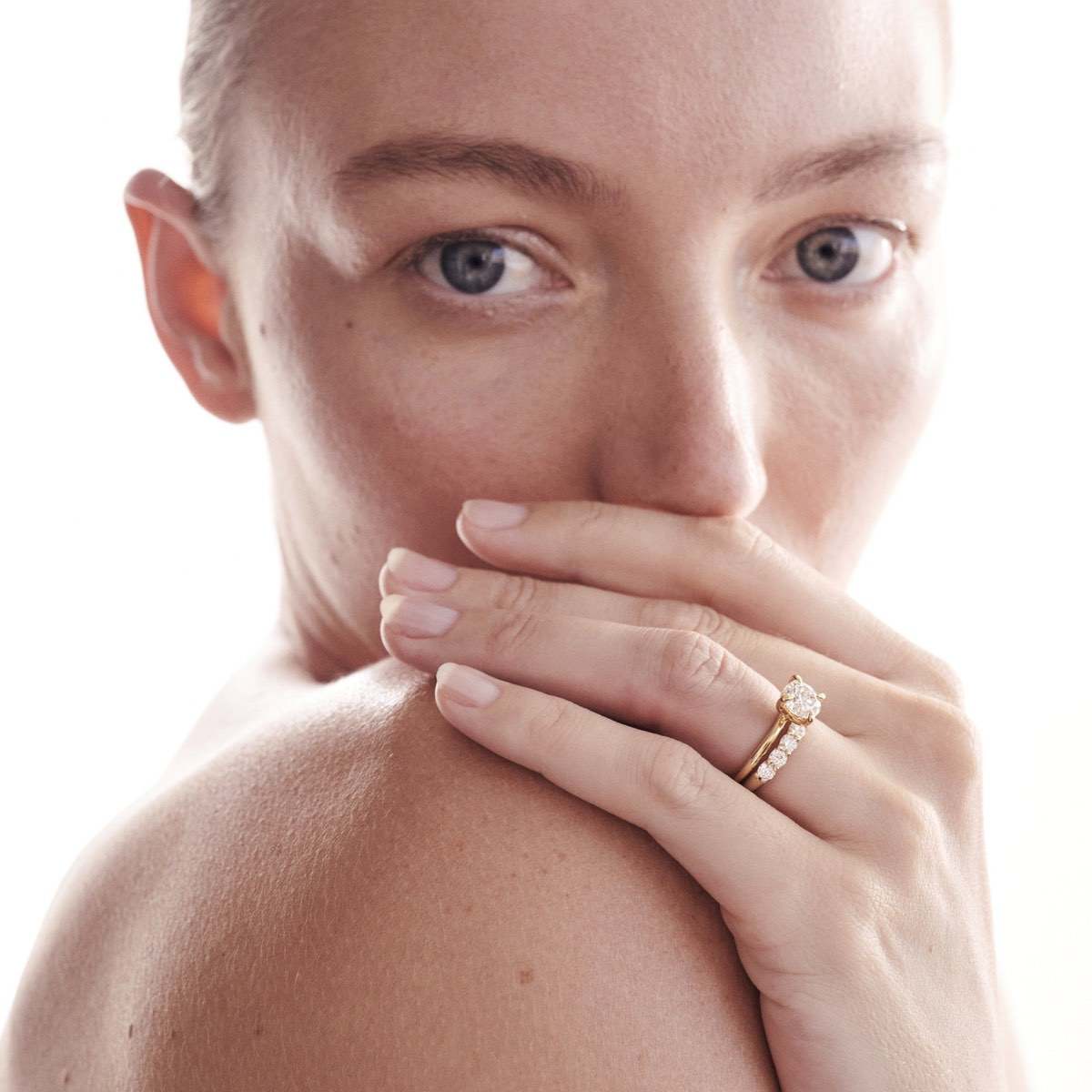 Model shot wearing Arraya 3mm diamond band featuring our Cleo lab grown diamond engagement ring, both set in 18ct yellow gold 