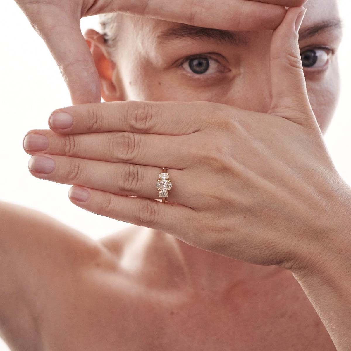 Our Ava ring showcases a brilliant oval cut centre stone shining between two smaller-sized shoulder stones. The centre stone size pictured is 1ct and the shoulder stones are 0.25ct each.