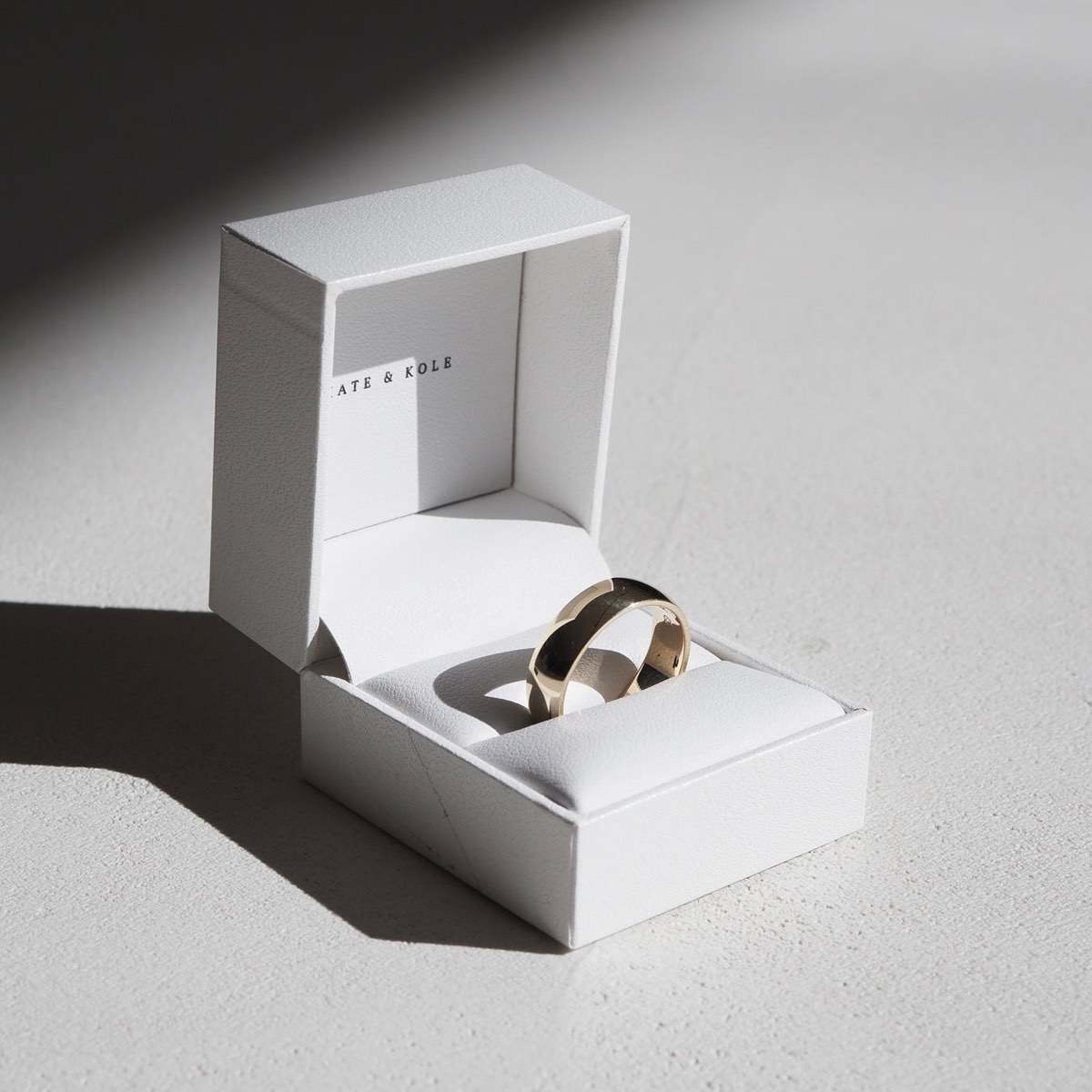 A simple bold band designed for comfort and simplicity, with a polished finish and soft curved edges. Photo featuring a low half round band, 6mm band width, 2mm band thickness and a polished finish. 