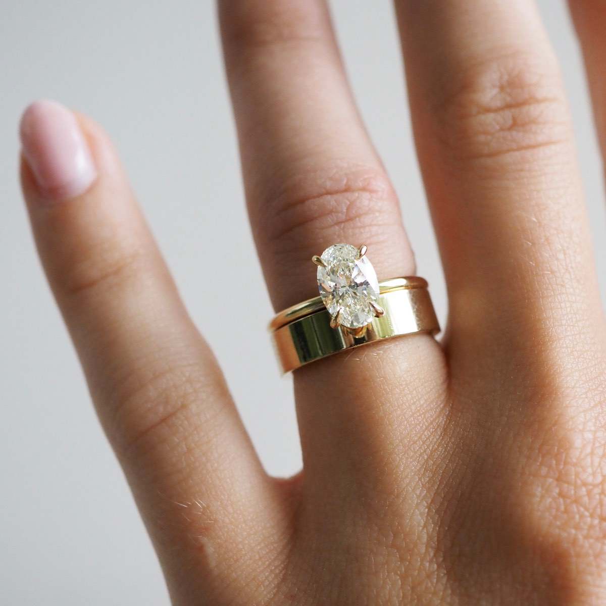 A heavy cigar band designed for comfort and simplicity, featuring a beautifully polished surface & straight square edges. Our Cigar band is 5mm wide, 1.75mm thick and a polished finish. Featuring our Clara lab grown diamond engagement ring. 