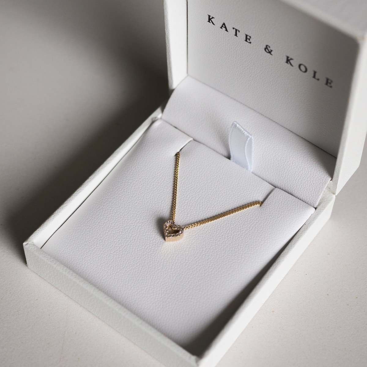 Our beautiful Diamond Heart Charm Necklace in 9ct yellow gold, sitting beautifully in a white K&K jewellery box