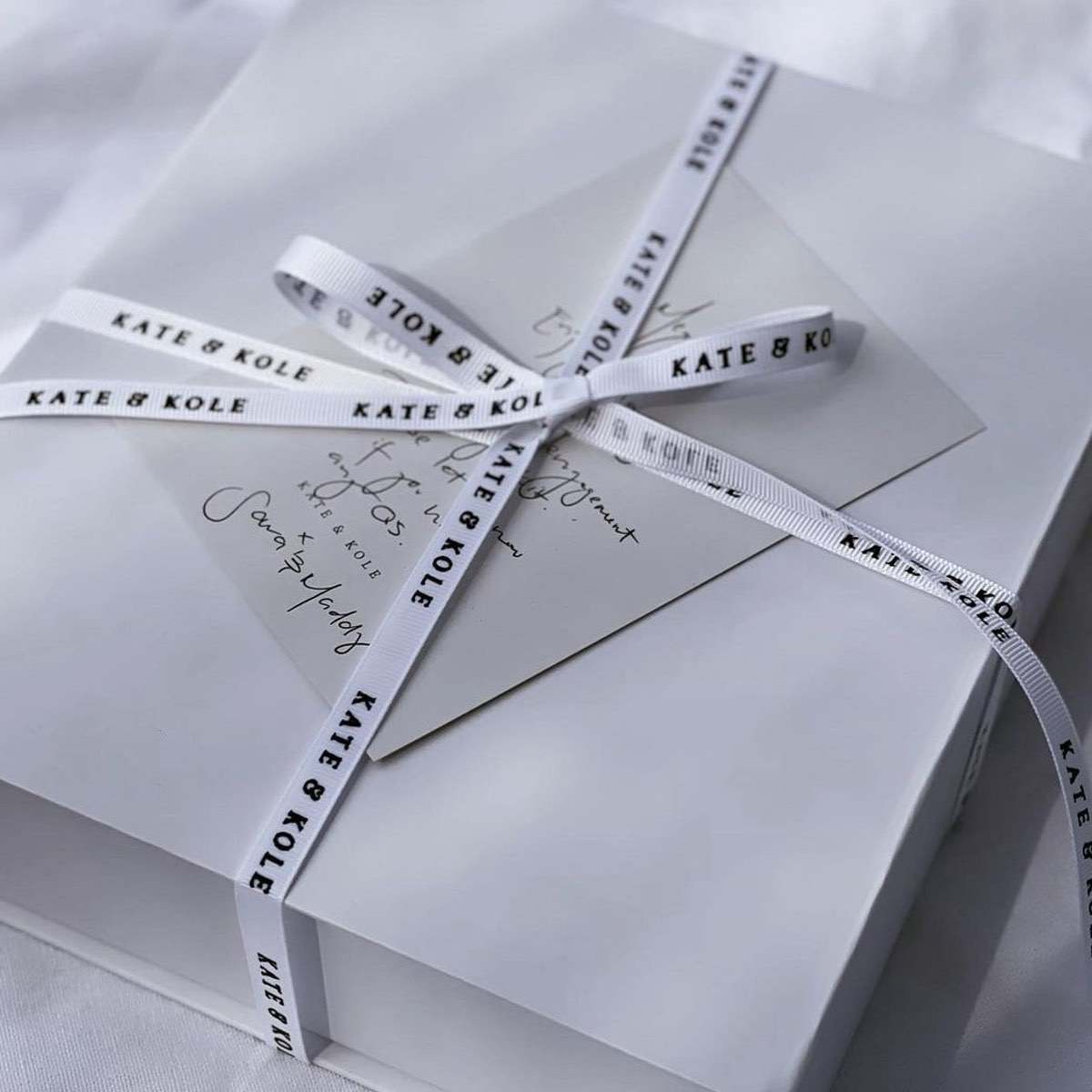 Kate and Kole packaging - box with K&K logo ribbon wrapped around it 