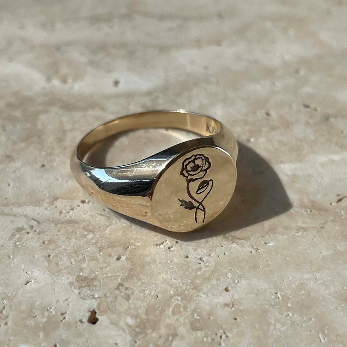 Round solid gold signet ring with an engraved rose on the face. Add a date, initials, images or words in a bespoke style to our customisable products. Choose from single letter (for tiny beads and charms) or multiple letters for dates and words.
