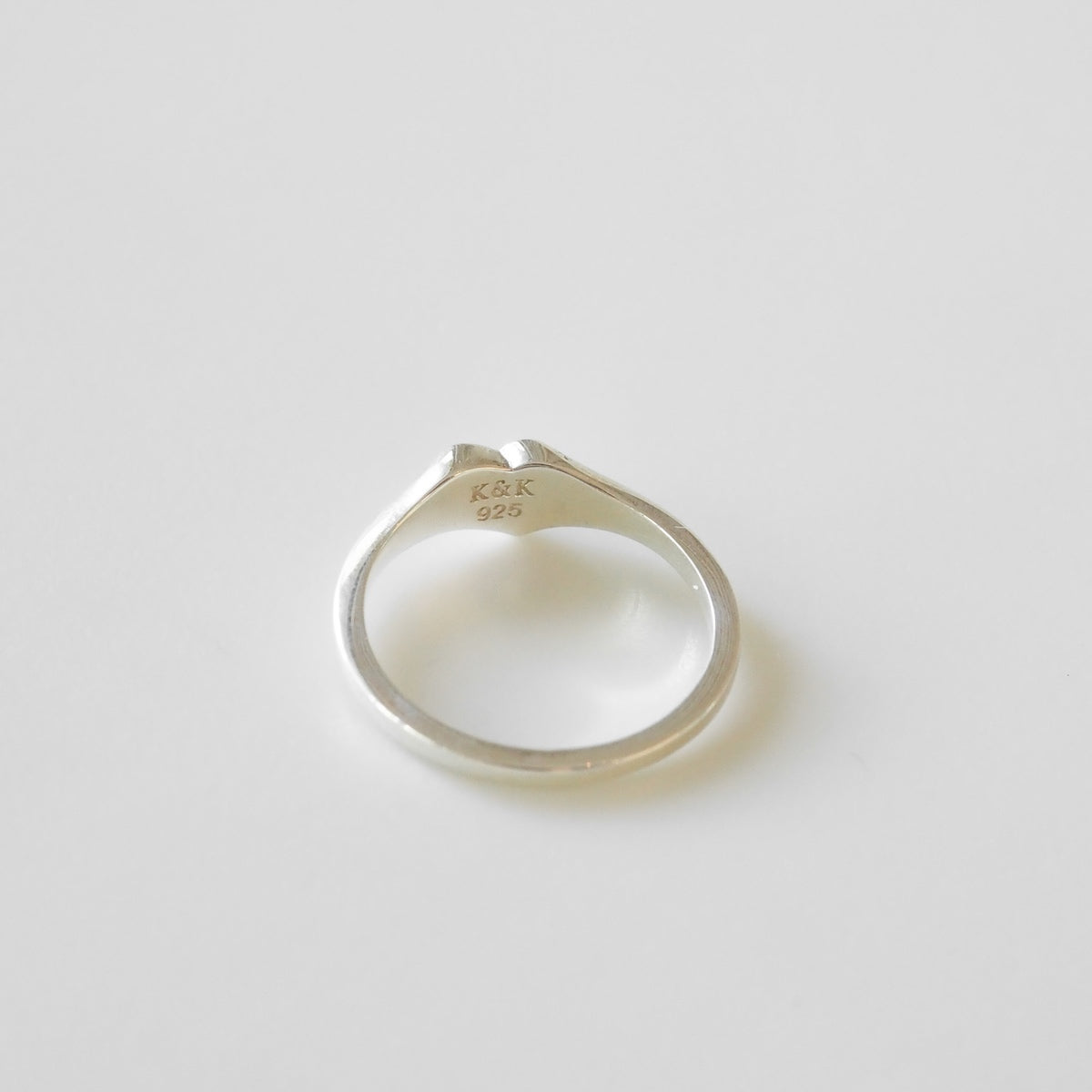 Silver ring on a light gray background