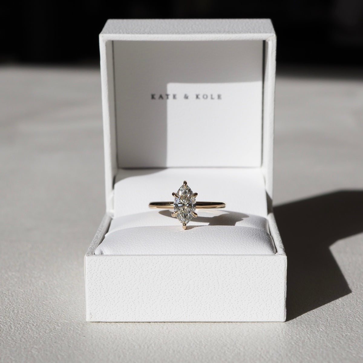 A mesmerising six claw solitaire engagement ring — showcasing the slender silhouette of a marquise cut lab-grown diamond - set in solid 18ct yellow gold.