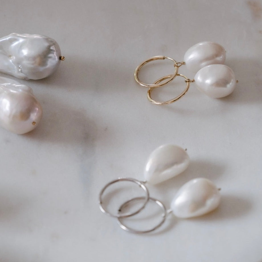 An array of our hand-wrapped solid gold and silver baroque pearl earring on 15mm and 20mm everyday sleepers.