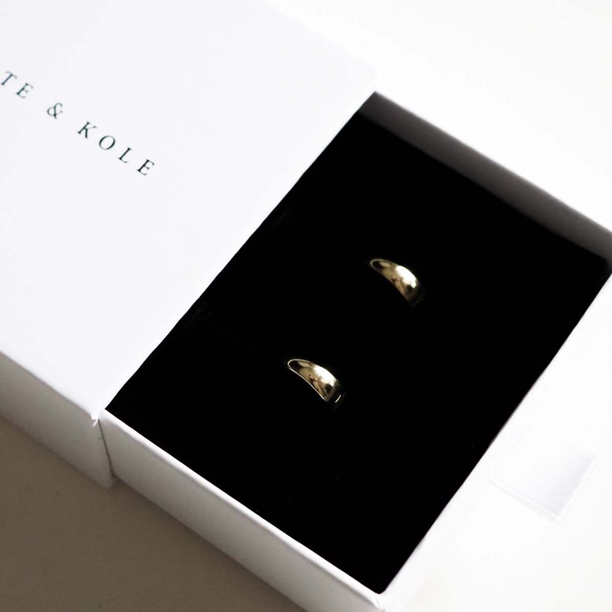 Our stunning solid gold tapered huggies sitting perfectly in our Kate & Kole jewellery box