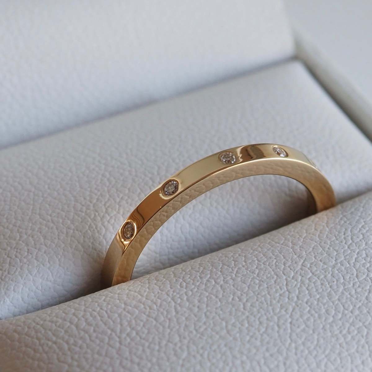 Four perfectly set flush stones on a beautifully weighted solid silver or gold band. 