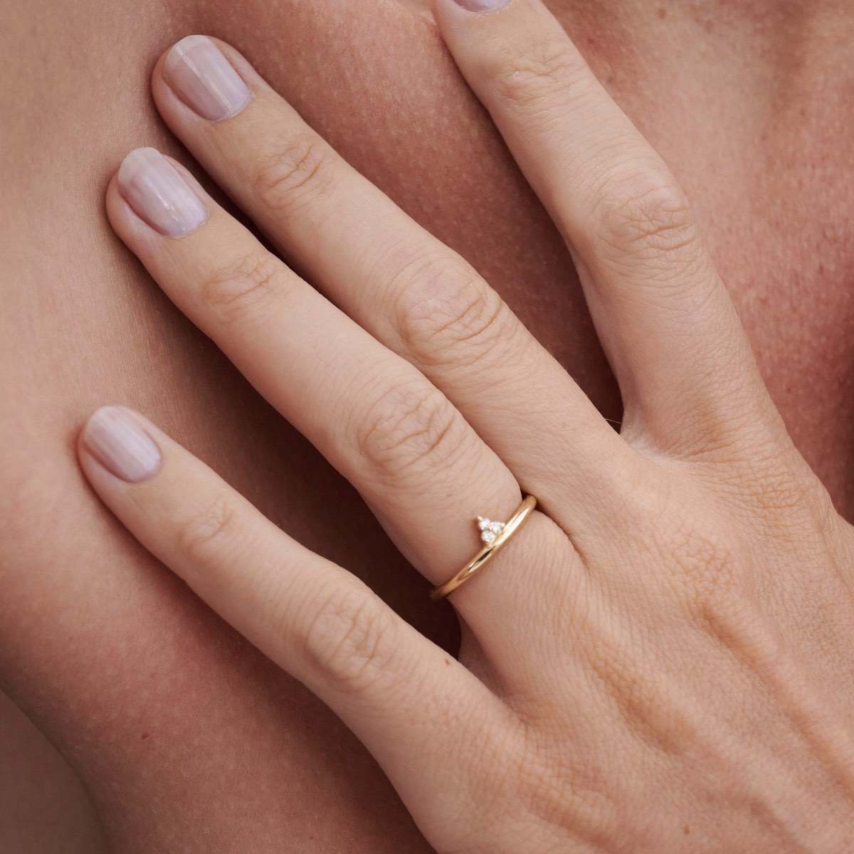 Model wears Therefore Ring with offset 3 stone cluster setting with lab grown diamonds in 9ct Yellow Gold
