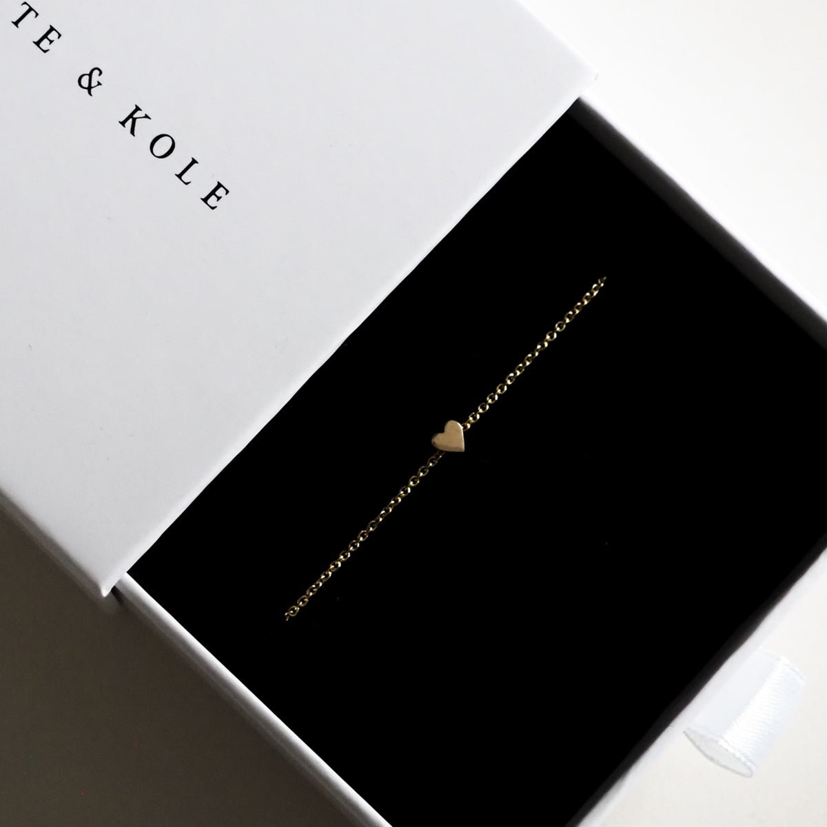 Solid Gold Tiny Heart Bracelet:17cm 9ct yellow gold tiny heart bracelet sits beautifully in a white Kate & Kole jewellery box