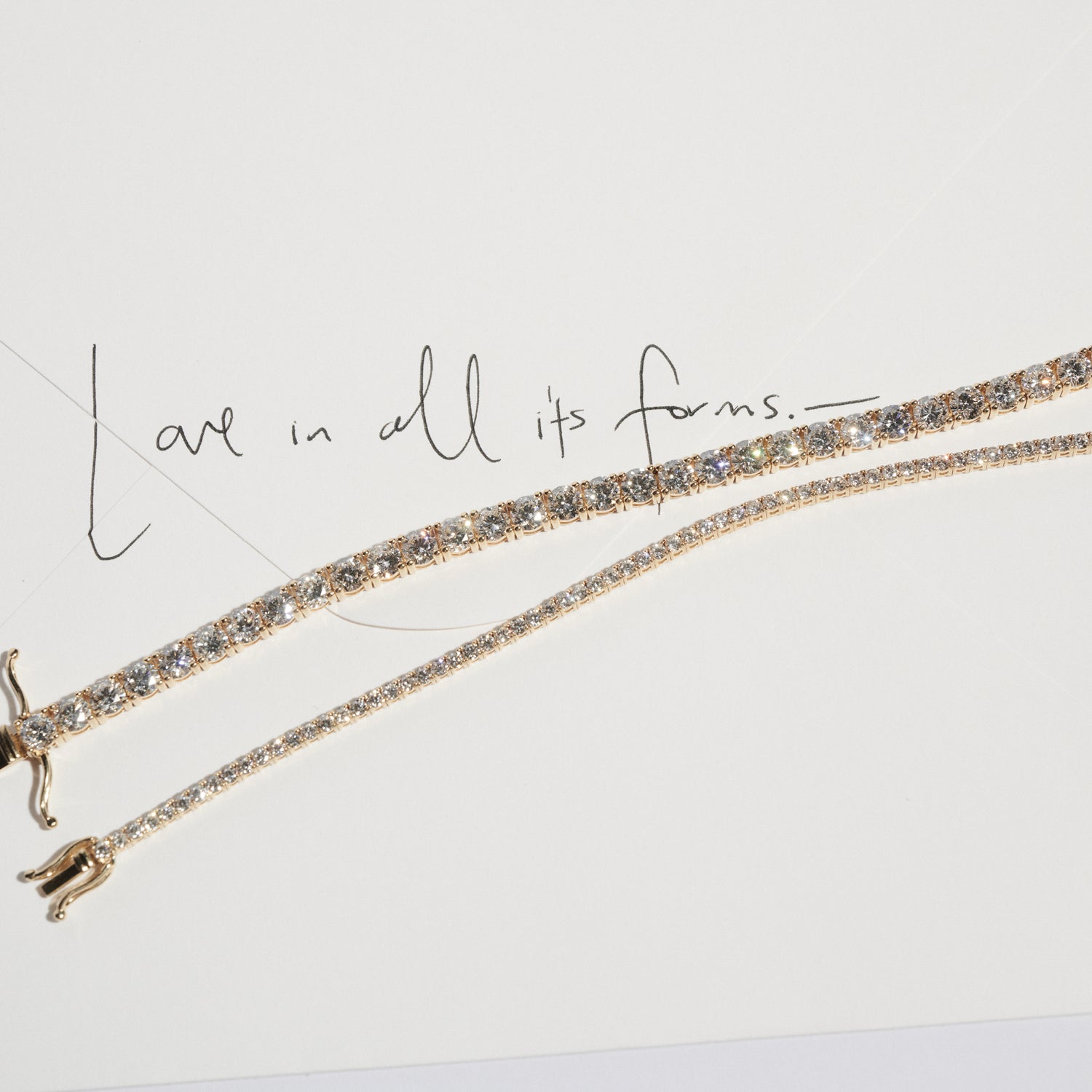 Gold bracelet with diamonds on a light gray background with text 'Love in all its forms'.