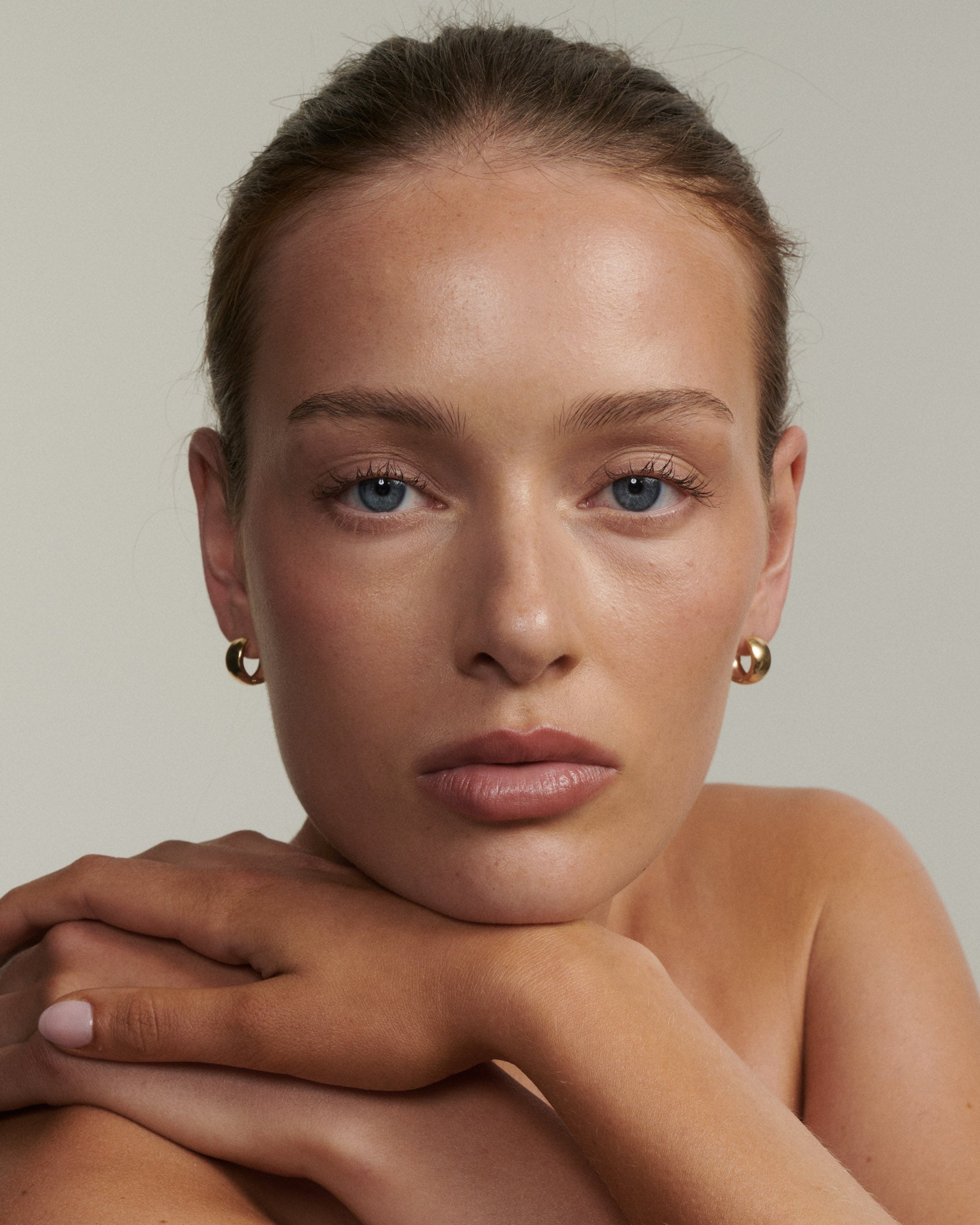 Woman with a neutral expression against a plain background