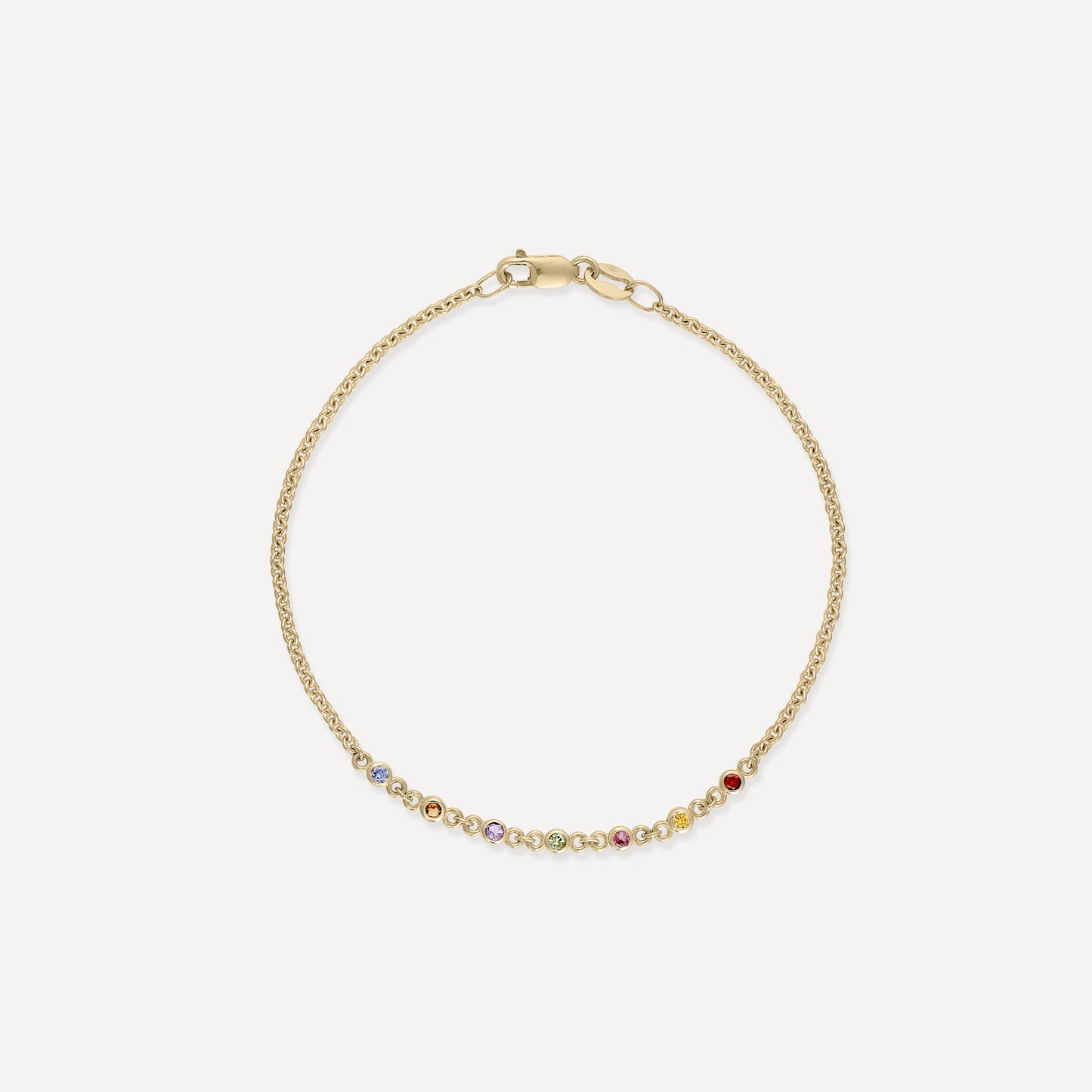 Gold bracelet with a delicate chain, featuring an array of colourful gemstones. Ideal for luxury fashion and jewellery lovers.