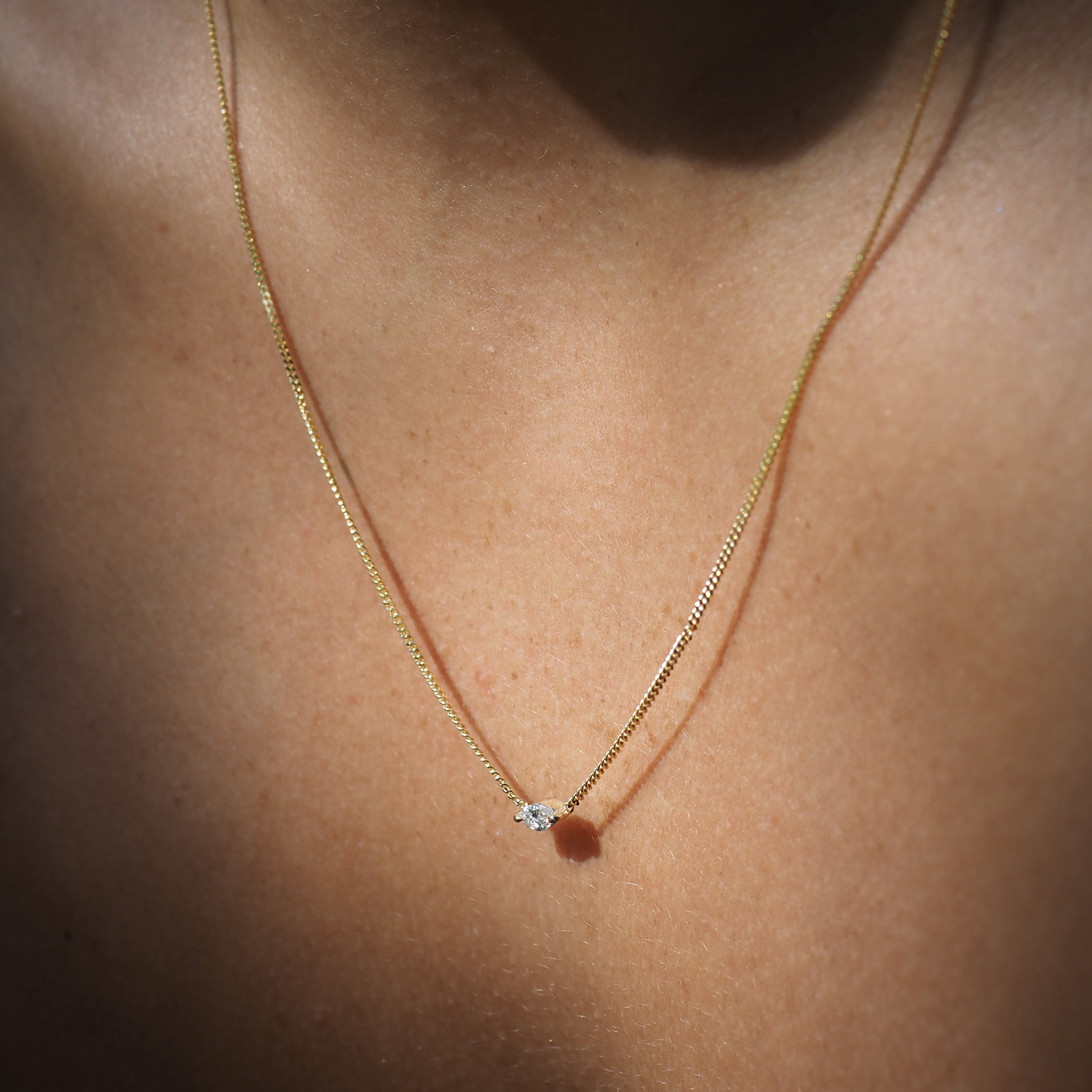 Marquise lab-grown diamond necklace, handset within two claws and featured on yellow gold chain. 