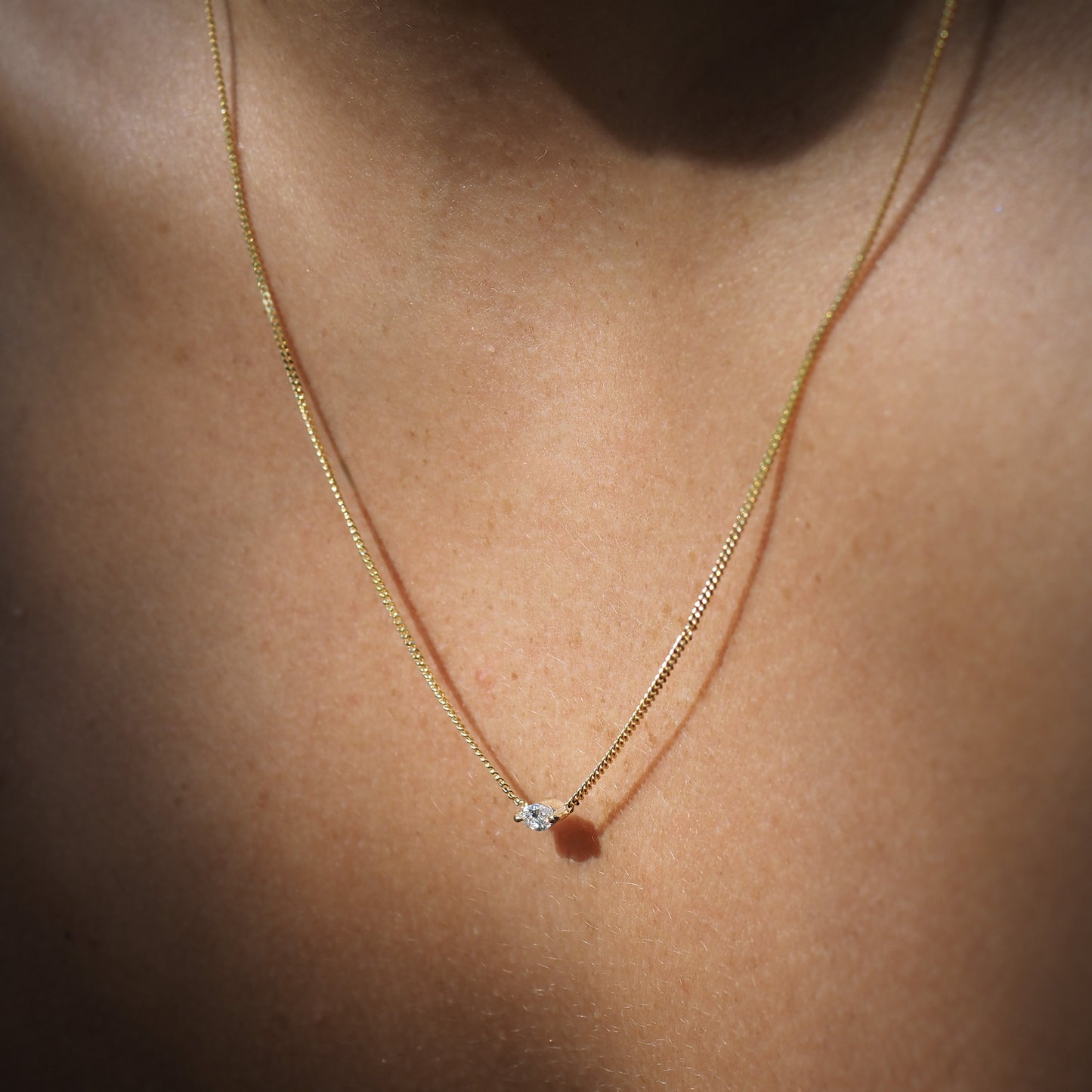 Marquise lab-grown diamond necklace, handset within two claws and featured on yellow gold chain.
