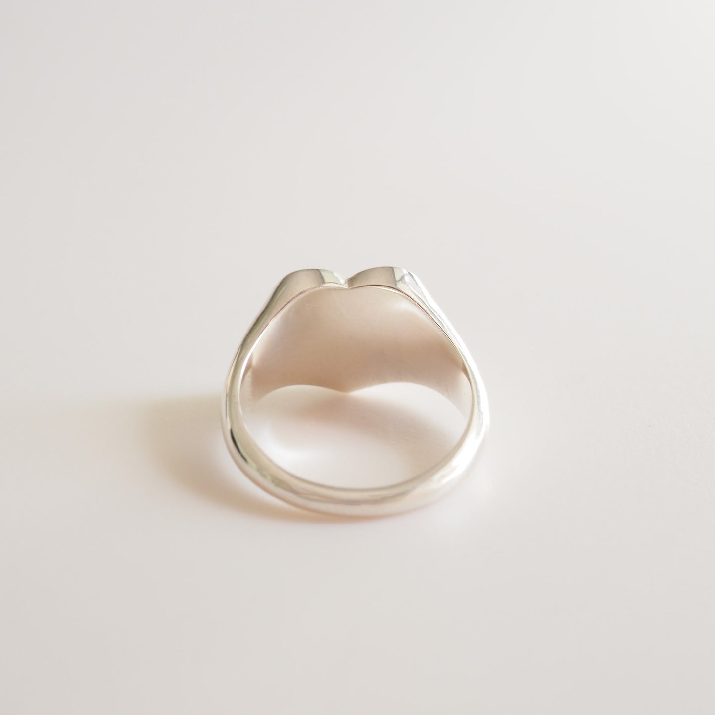 Silver ring on a light gray background
