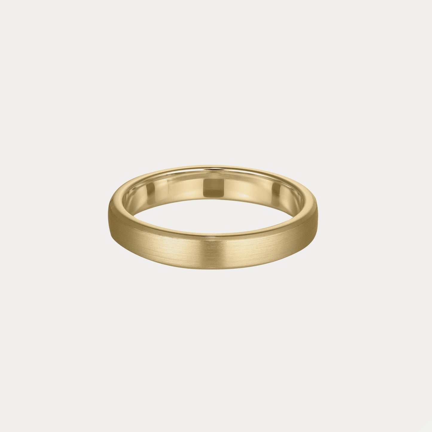 Gold wedding band with a brushed matte finish, set against a plain off-white background. Classic and elegant luxury jewellery piece.