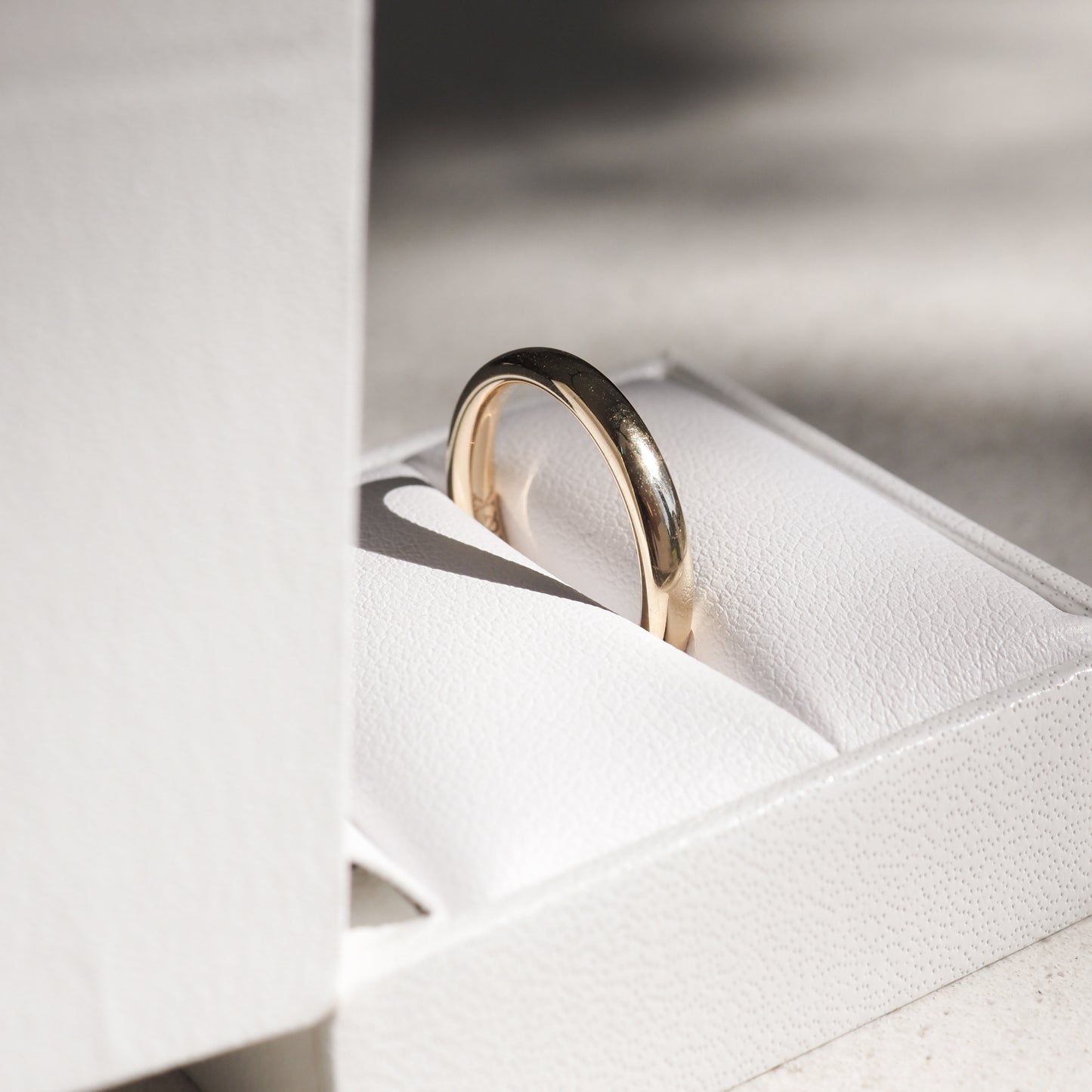 A weighted half-round band in solid 18ct yellow gold.