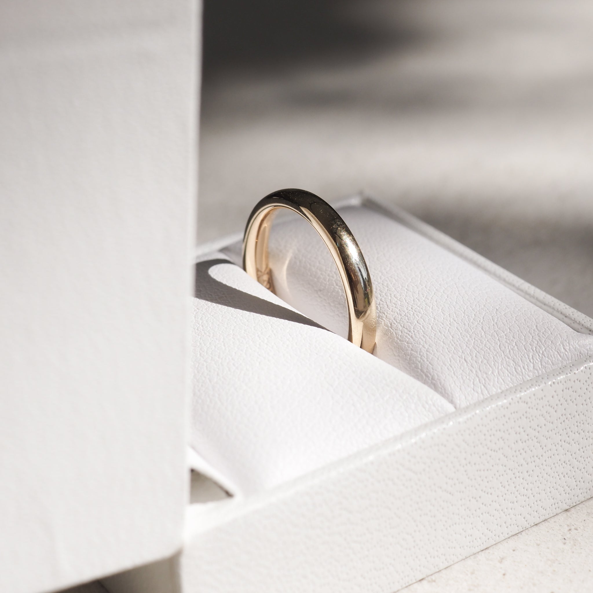 A weighted half-round band in solid 18ct yellow gold.