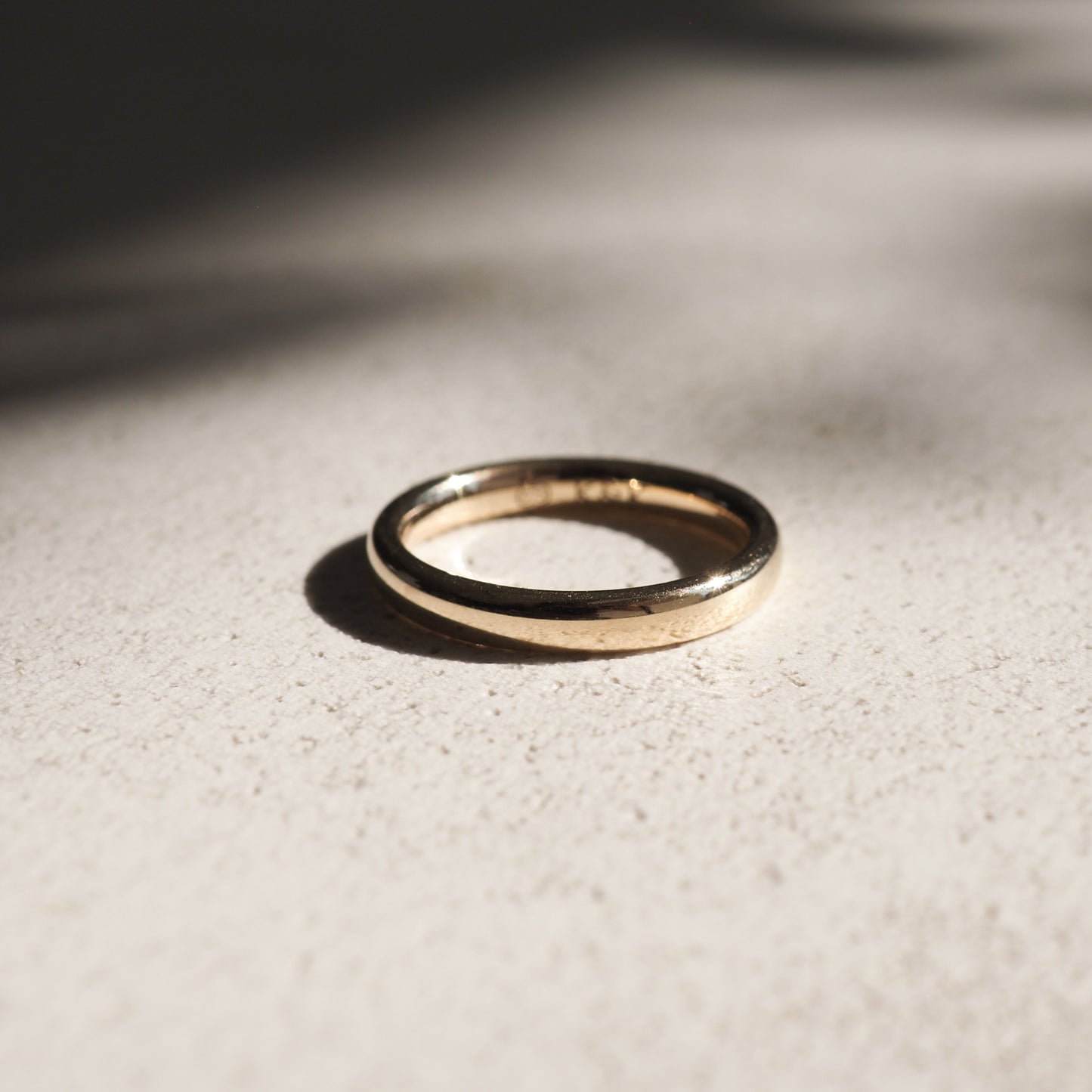 A weighted half-round band in solid 18ct yellow gold. 
