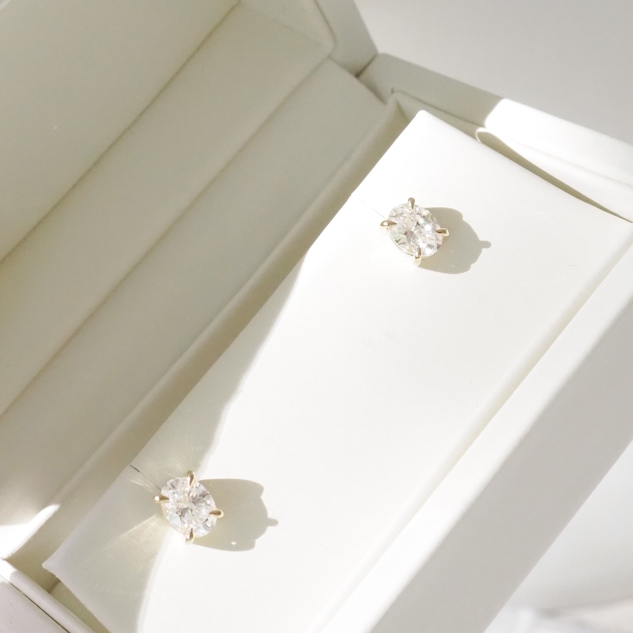 Oval Diamond Studs in cream box on a white backdrop