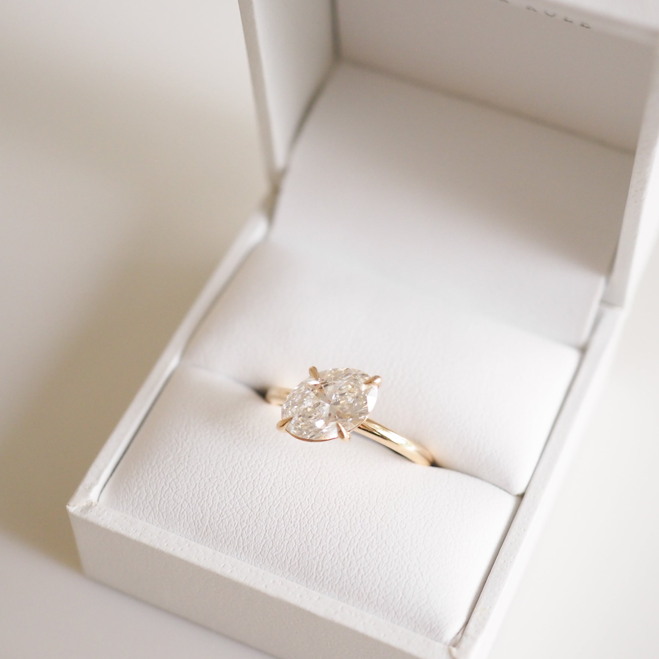 Marquise diamond ring in an elegant white jewellery box, showcasing luxury design with a gold band, ideal for high-end Australian jewellery lovers.