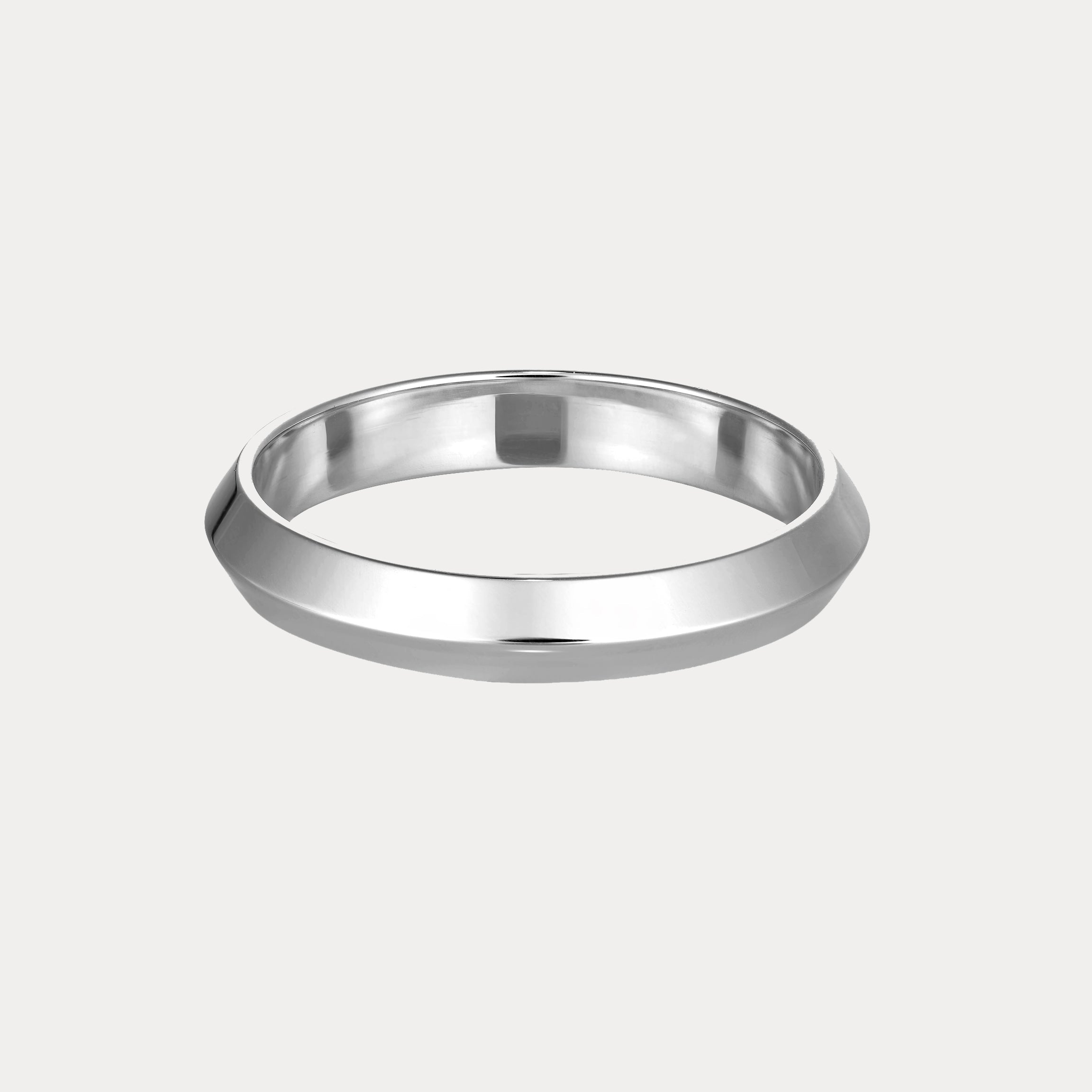 Sleek silver bangle with a geometric design, showcasing minimalist elegance against a pale background, epitomising luxury jewellery.