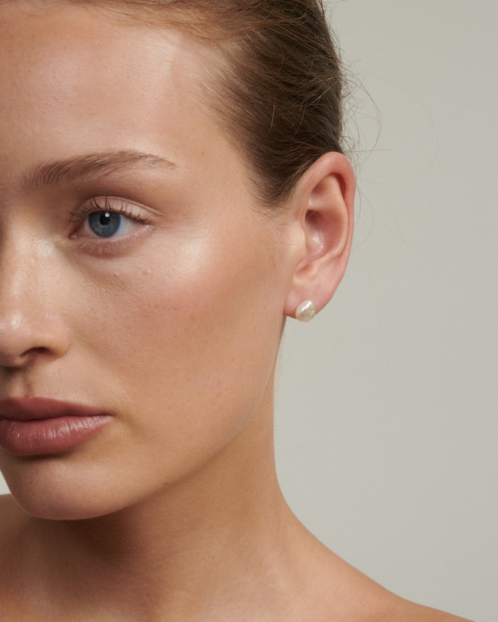 Close-up of a woman's face with a neutral background