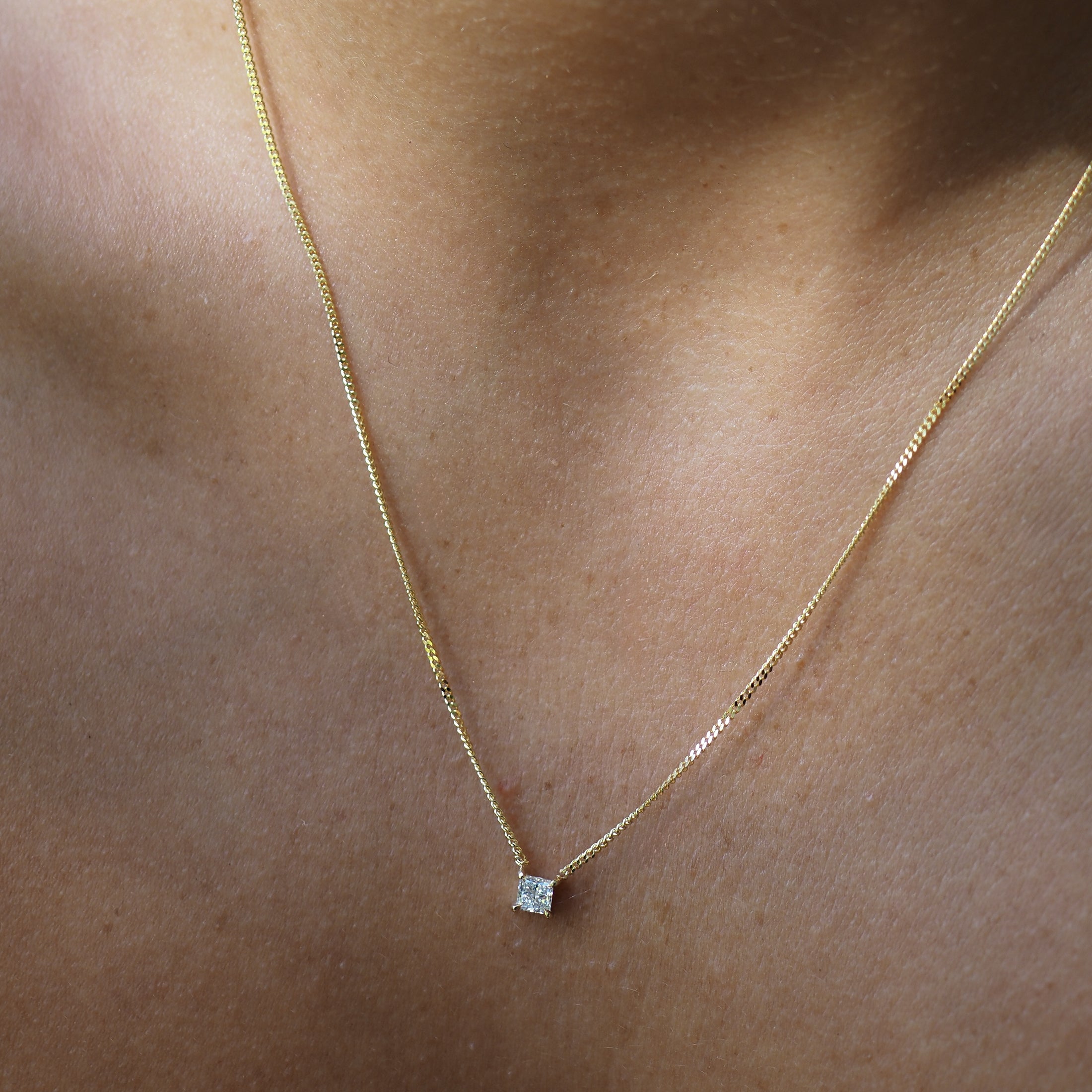 The Princess Diamond Necklace is fixed along a yellow gold chain and features a square cut lab-grown diamond handset within four claws. 