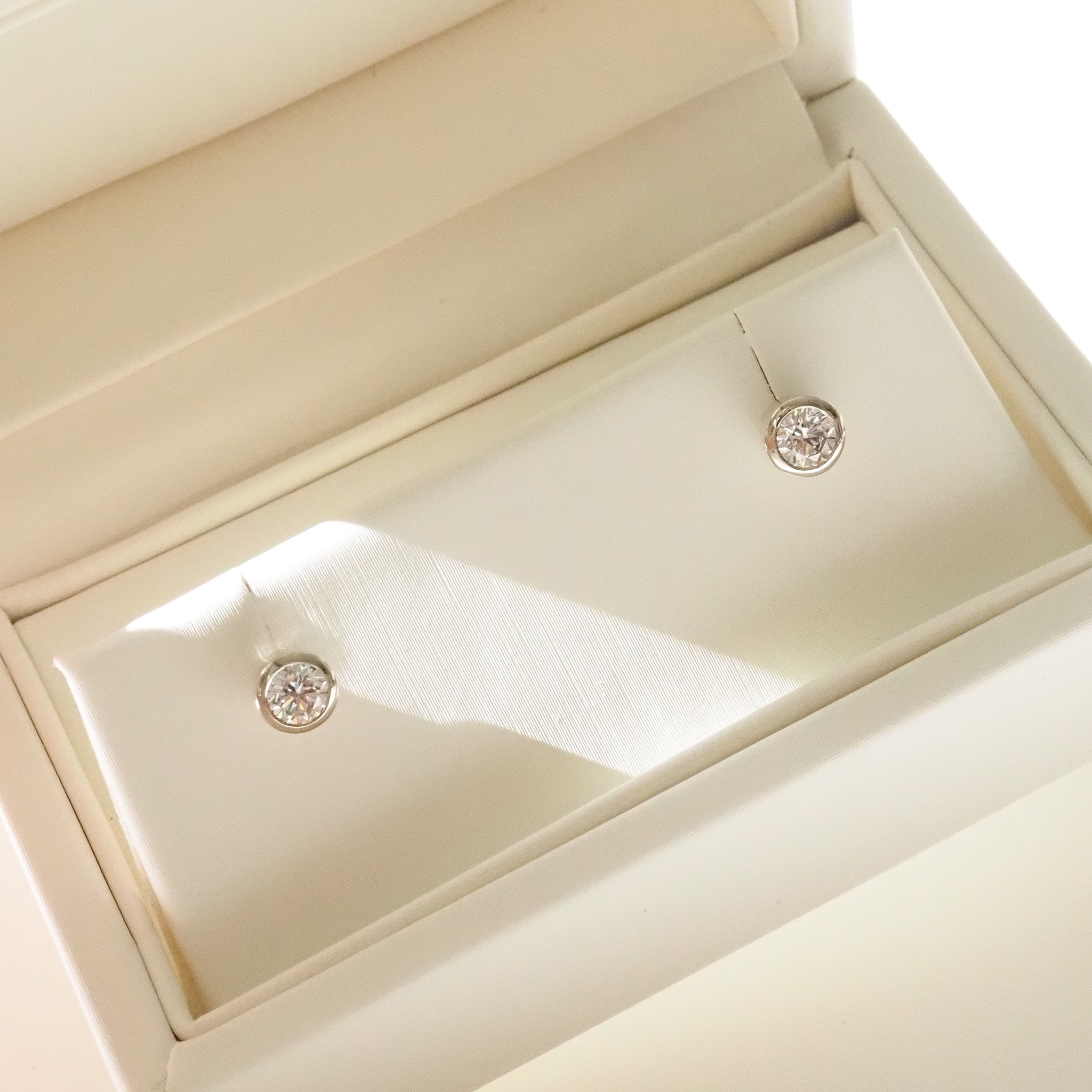 Round Bezel Diamond earrings in a jewelry box