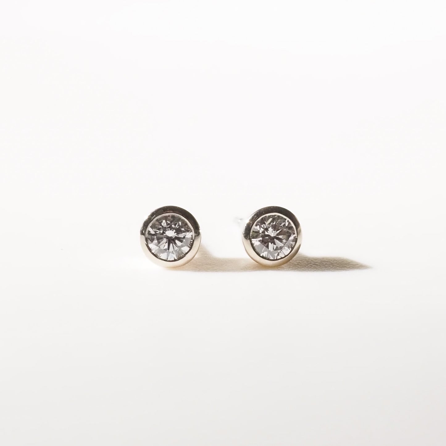 Pair of diamond stud earrings on a white background