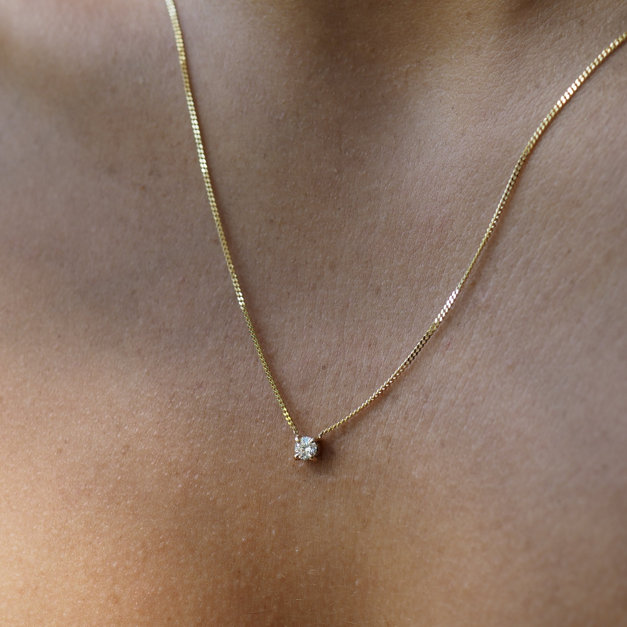 The Round Diamond Necklace features a circular lab-grown diamond among a yellow gold chain, handset within four claws. 