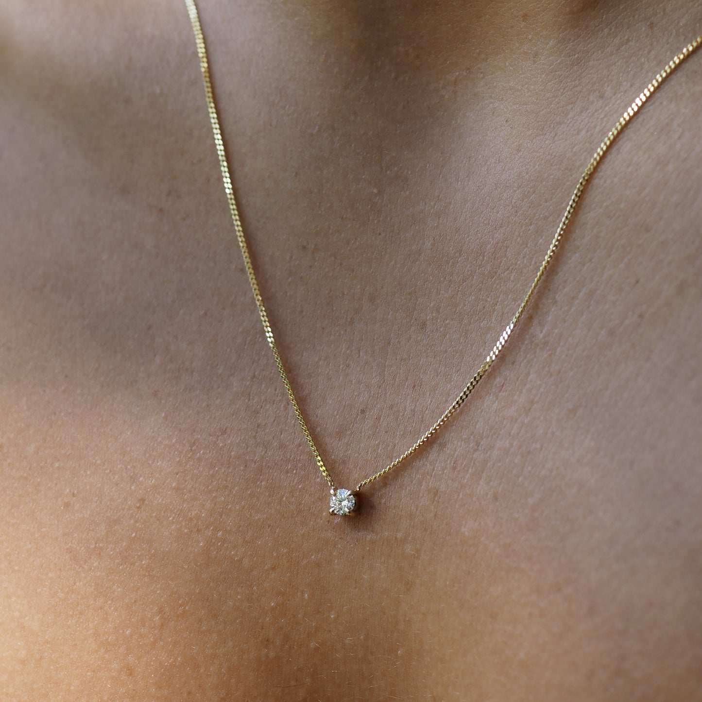The Round Diamond Necklace features a circular lab-grown diamond among a yellow gold chain, handset within four claws.