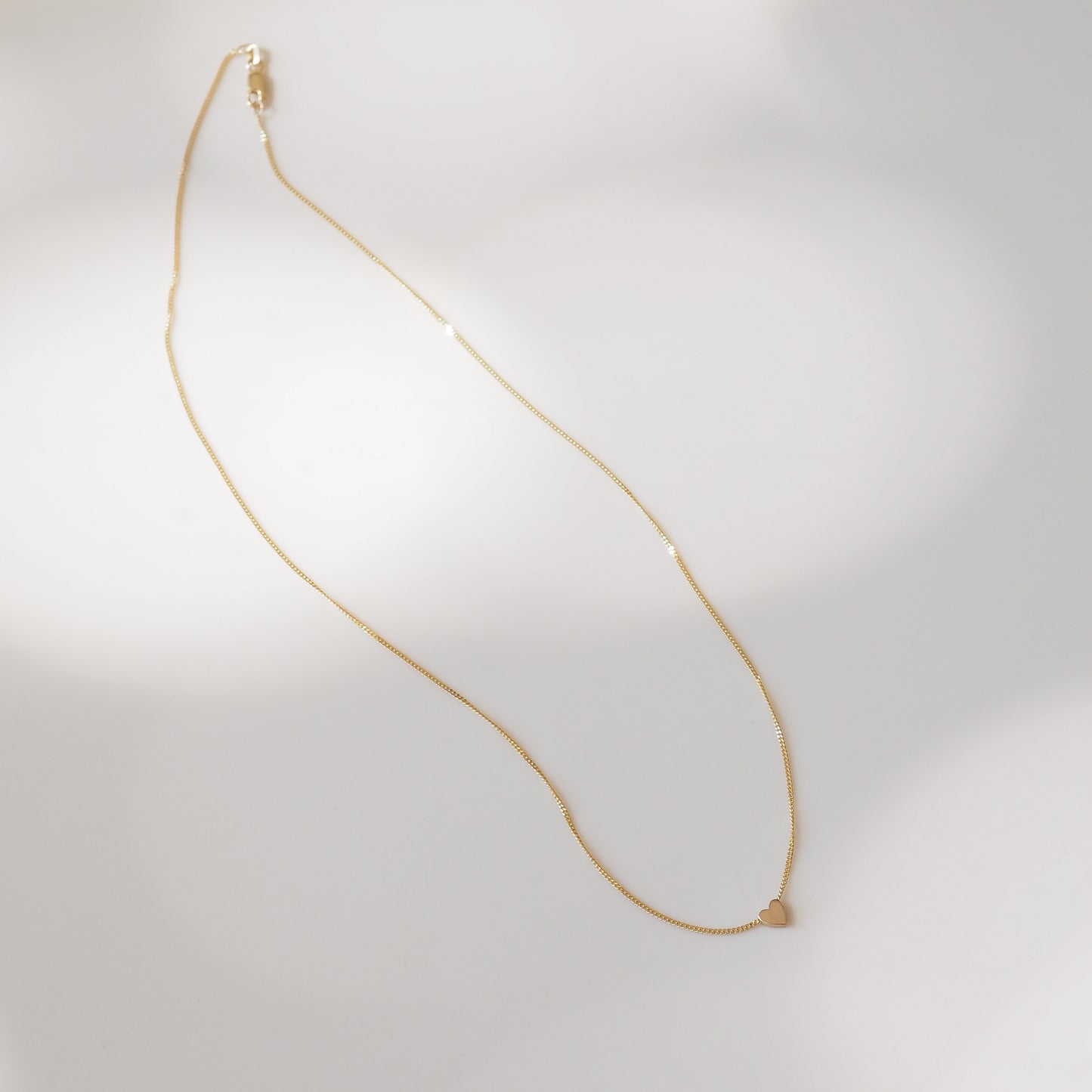 Heart charm on yellow gold chain