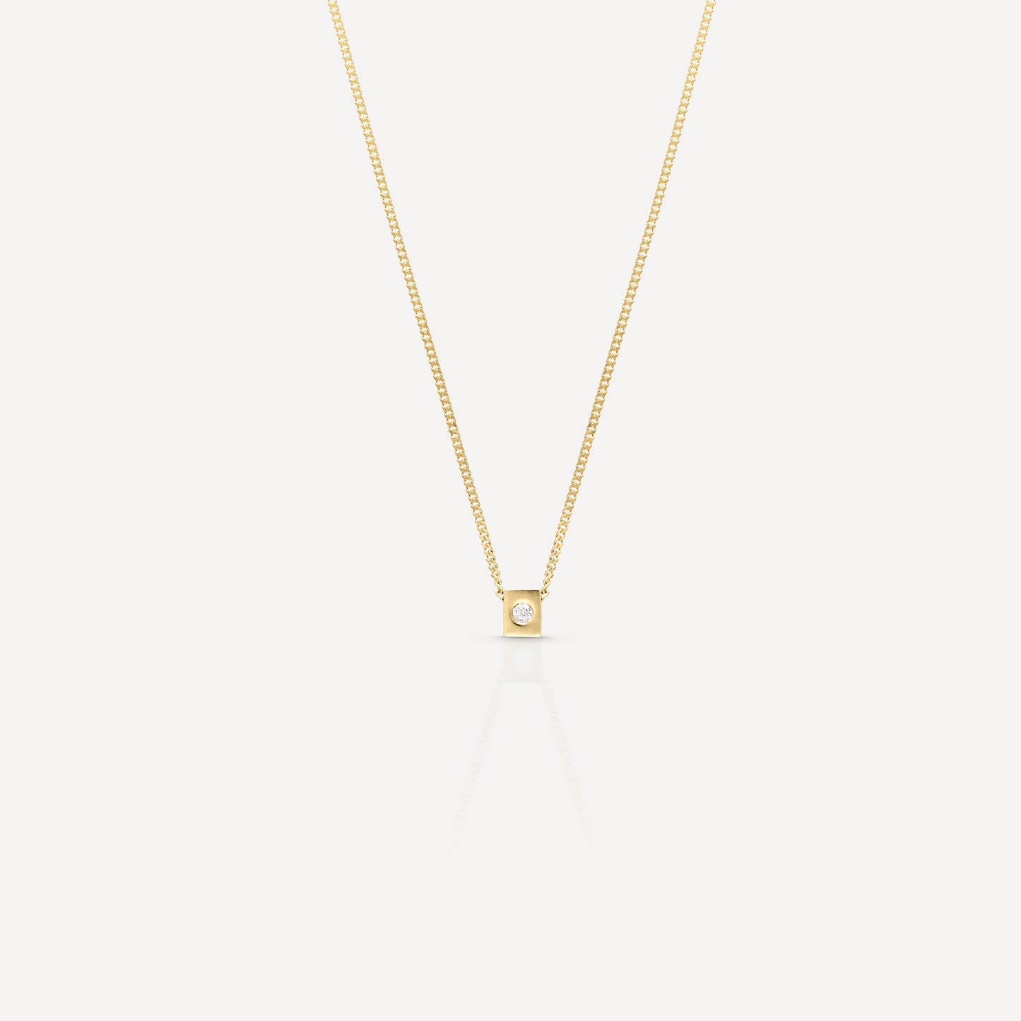 Gold necklace with a delicate chain and square pendant featuring a central diamond. Elegant and minimalist luxury jewellery piece.