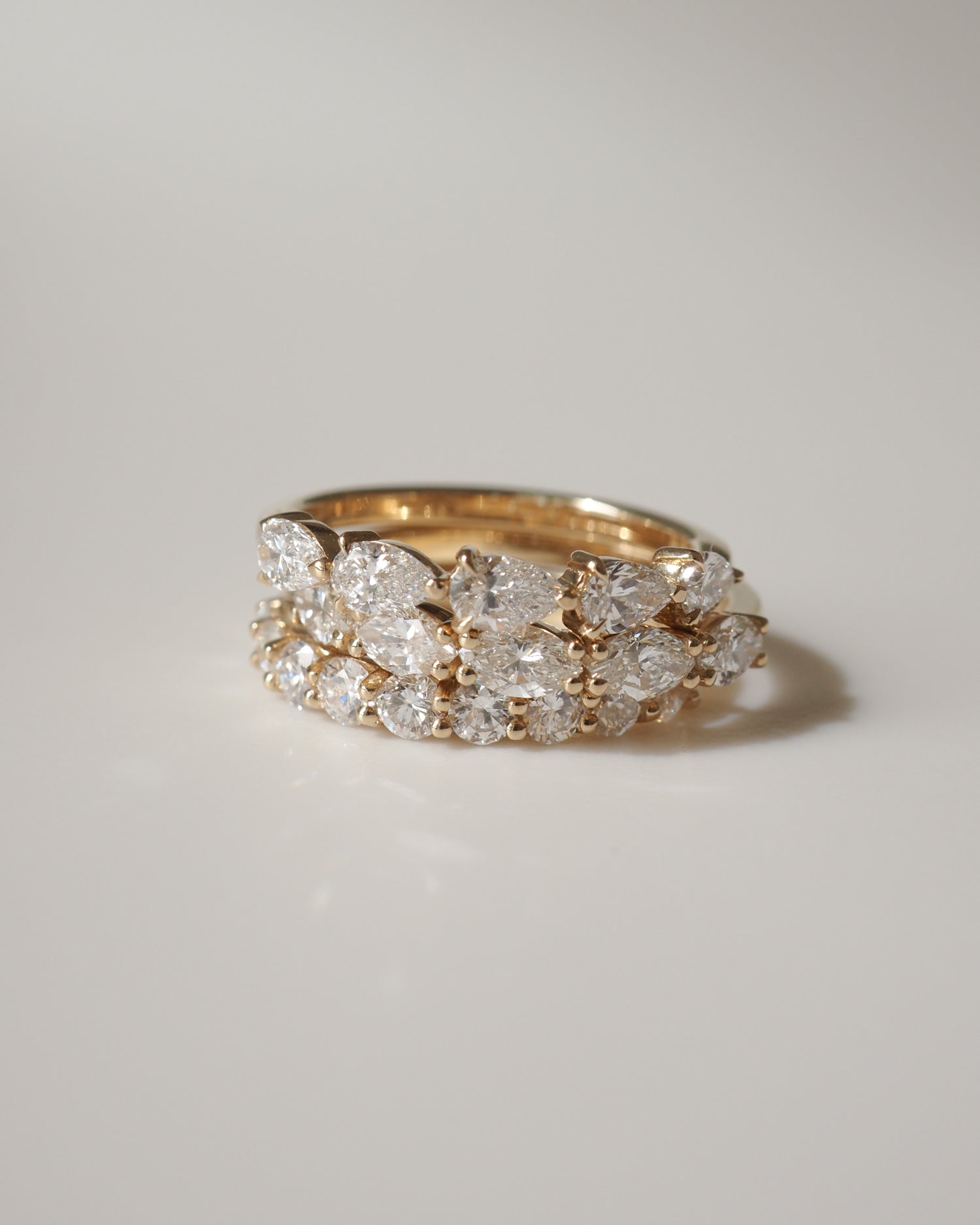 Gold ring adorned with sparkling diamonds, capturing an elegant and luxurious jewellery design on a soft-focus background.