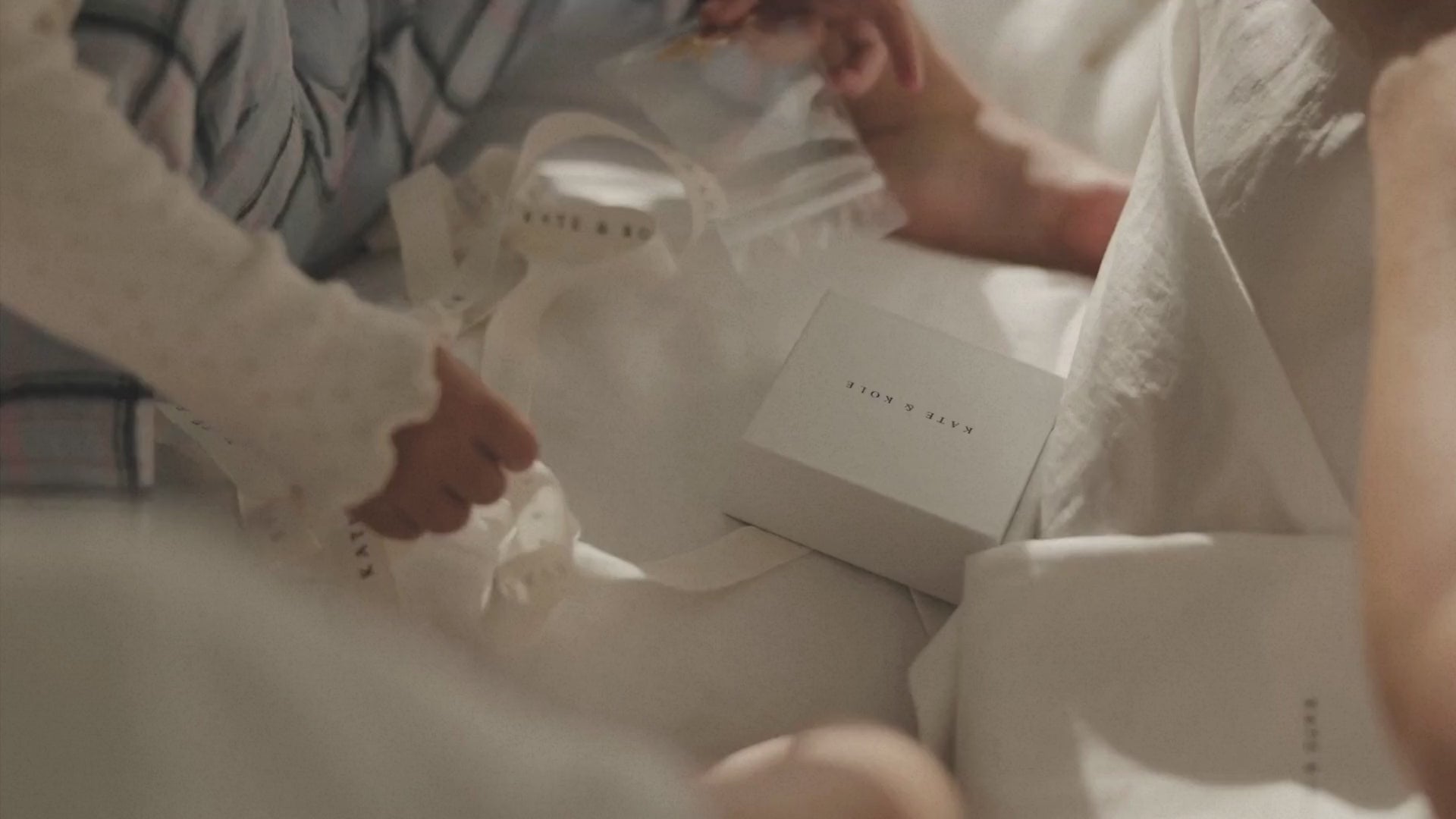 Children and mother engaged in a drawing a heart for hand man jewellery design.