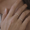 Video of models hands featuring our 18ct yellow gold 2mm Amaré band and 18ct yellow gold 1.4mm Arraya band beside each other on her hands 