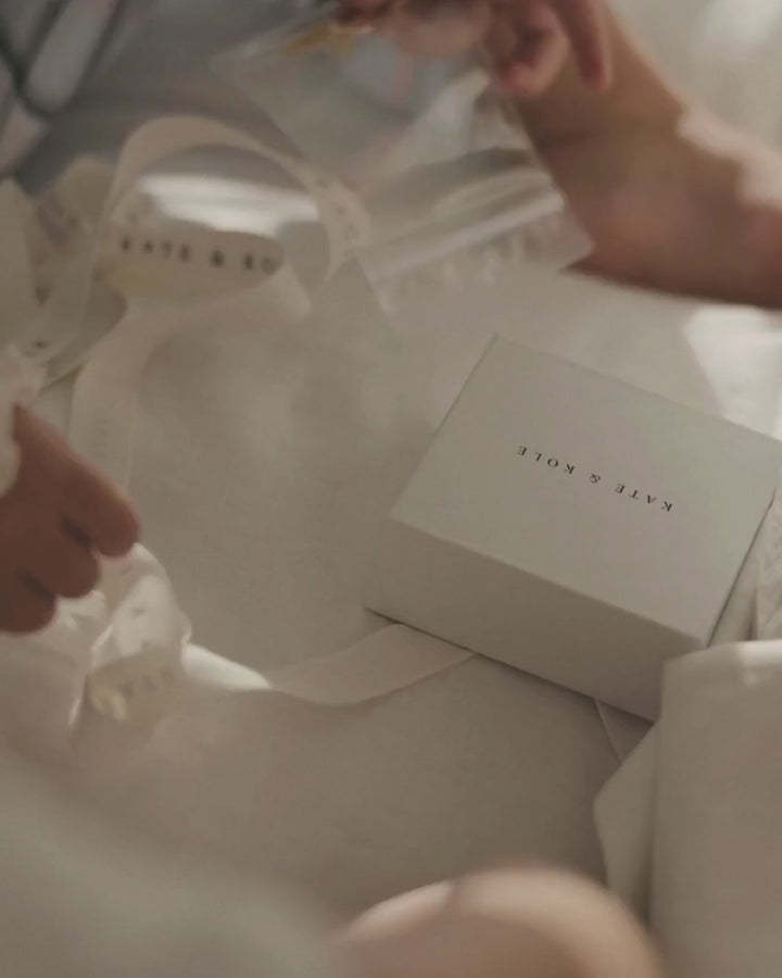 Children and mother engaged in a drawing a heart for hand man jewellery design.