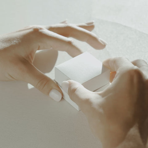 Video of Kate and Kole white leather ring box opening featuring our 18ct yellow gold Amaré 1.4mm diamond wedding band sitting in the box 