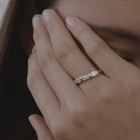 Celine is created with five emerald-cut lab-grown diamonds. The approximate total carat weight of this piece is 1.75ct. An elegant half-infinity row of five emerald cut lab-grown diamonds — secured seamlessly by solid gold bar settings.