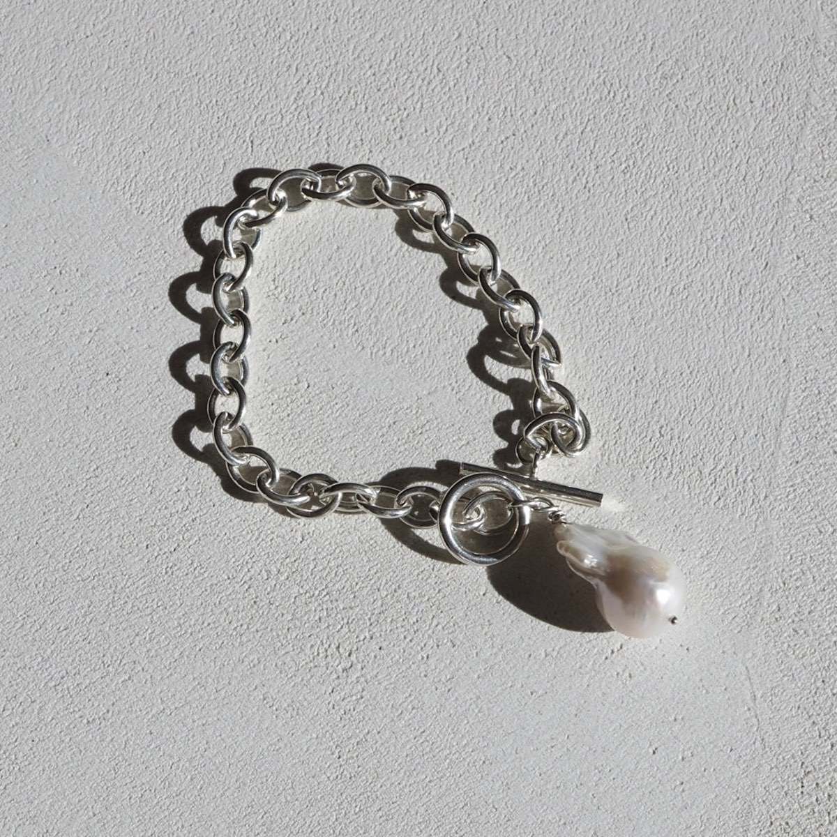 Hand wrapped freshwater baroque pearl: Beautiful sterling silver baroque pearl fob bracelet drenched in sunlight