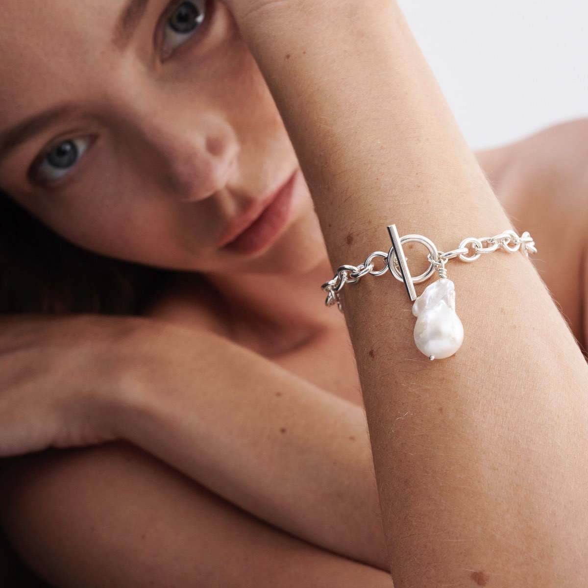 Hand wrapped freshwater baroque pearl: Model wears a beautiful sterling silver baroque pearl fob bracelet