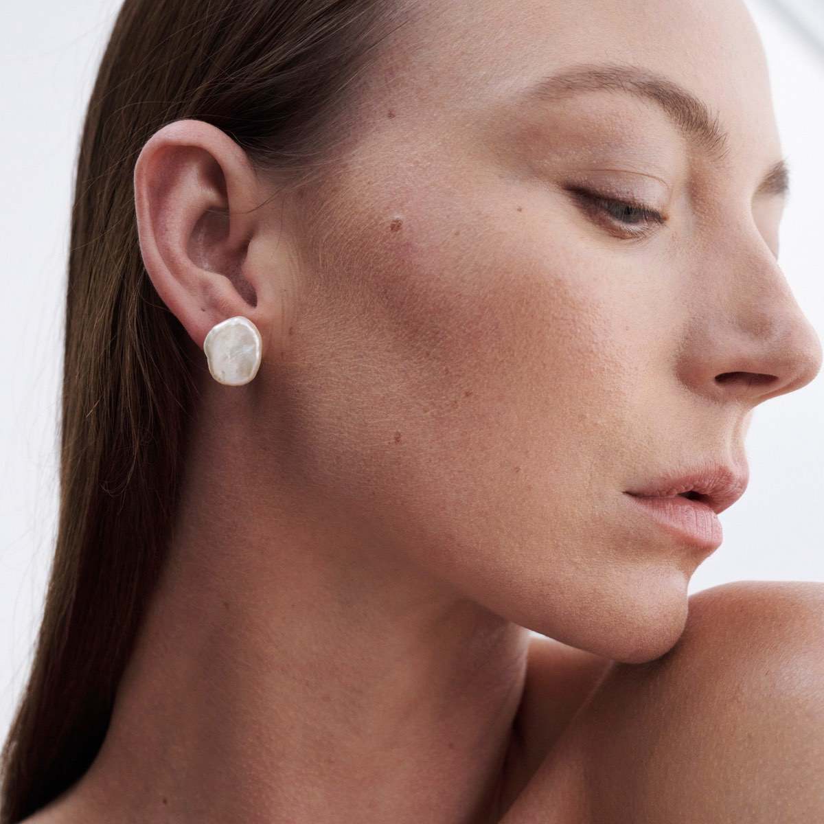 High quality hand made jewellery: Model wears our beautiful large baroque pearl studs in 9ct yellow gold.