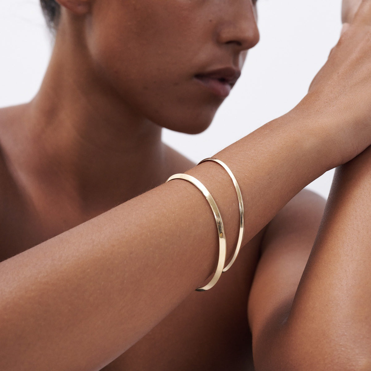 Model wears a 3mm and 5mm Solid 9ct Yellow Gold Knife Edge bangle