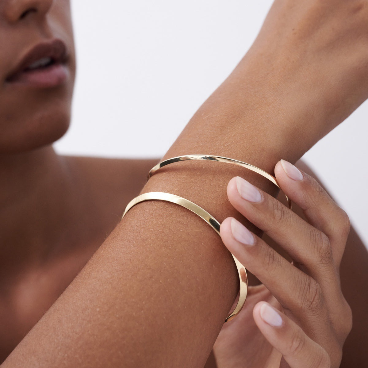 Model wears a 3mm and 5mm Solid 9ct Yellow Gold Knife Edge bangle