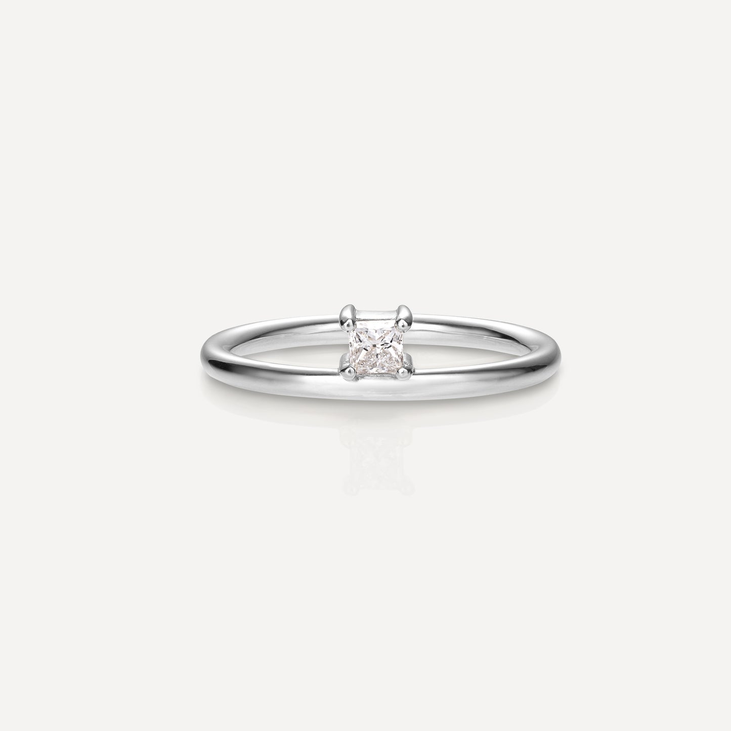 Elegant solitaire diamond engagement ring with a minimalist white gold band, showcasing luxury jewellery design.